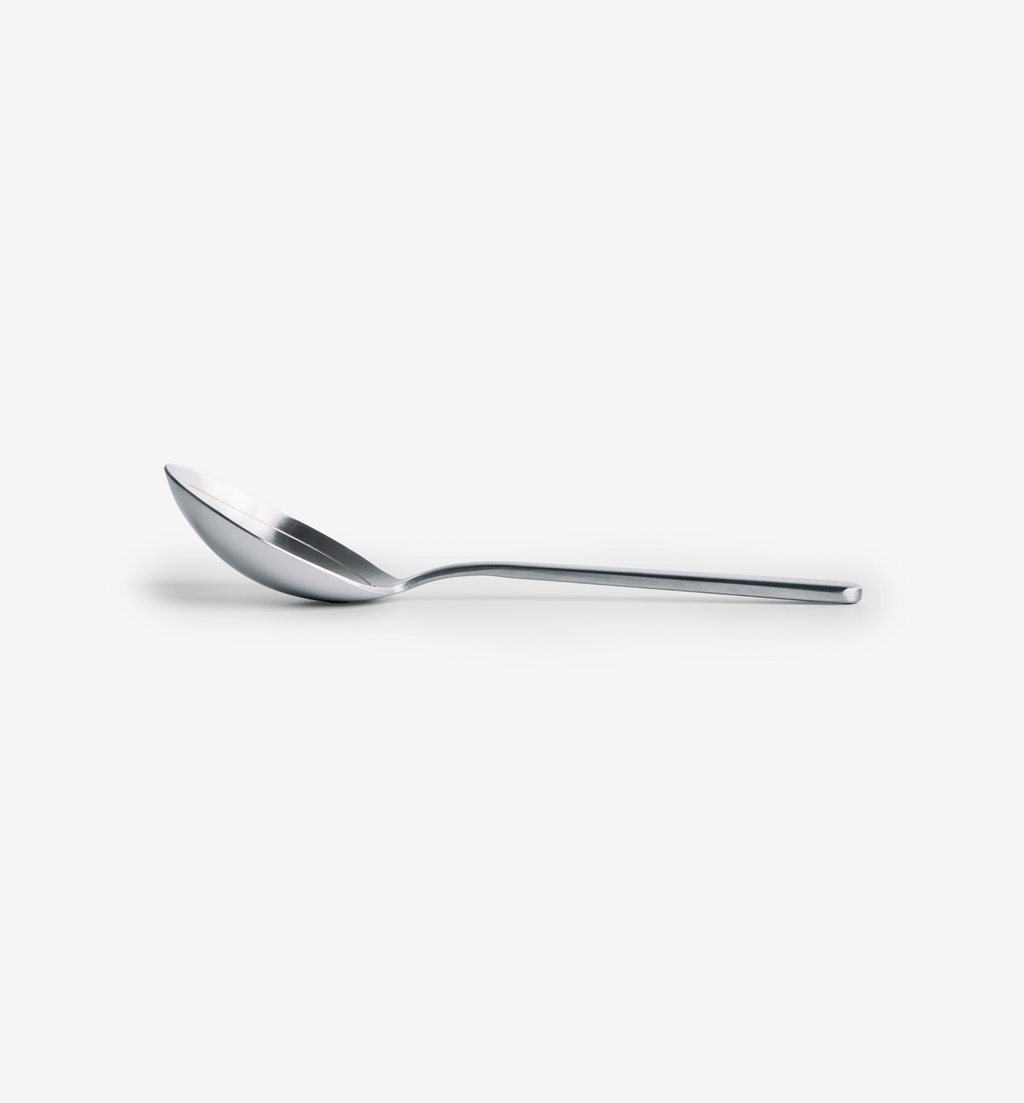 Polished stainless steel spoon with slim handle and deep bowl